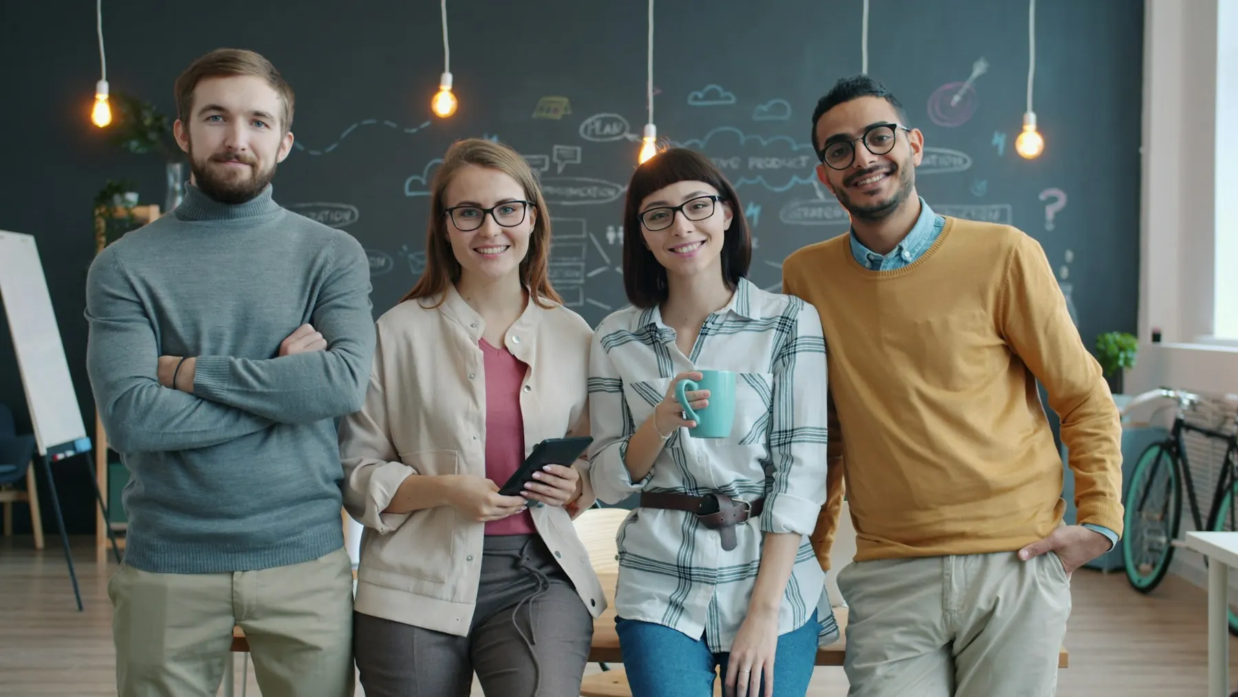 Confident, smiling business team standing together in a modern workplace