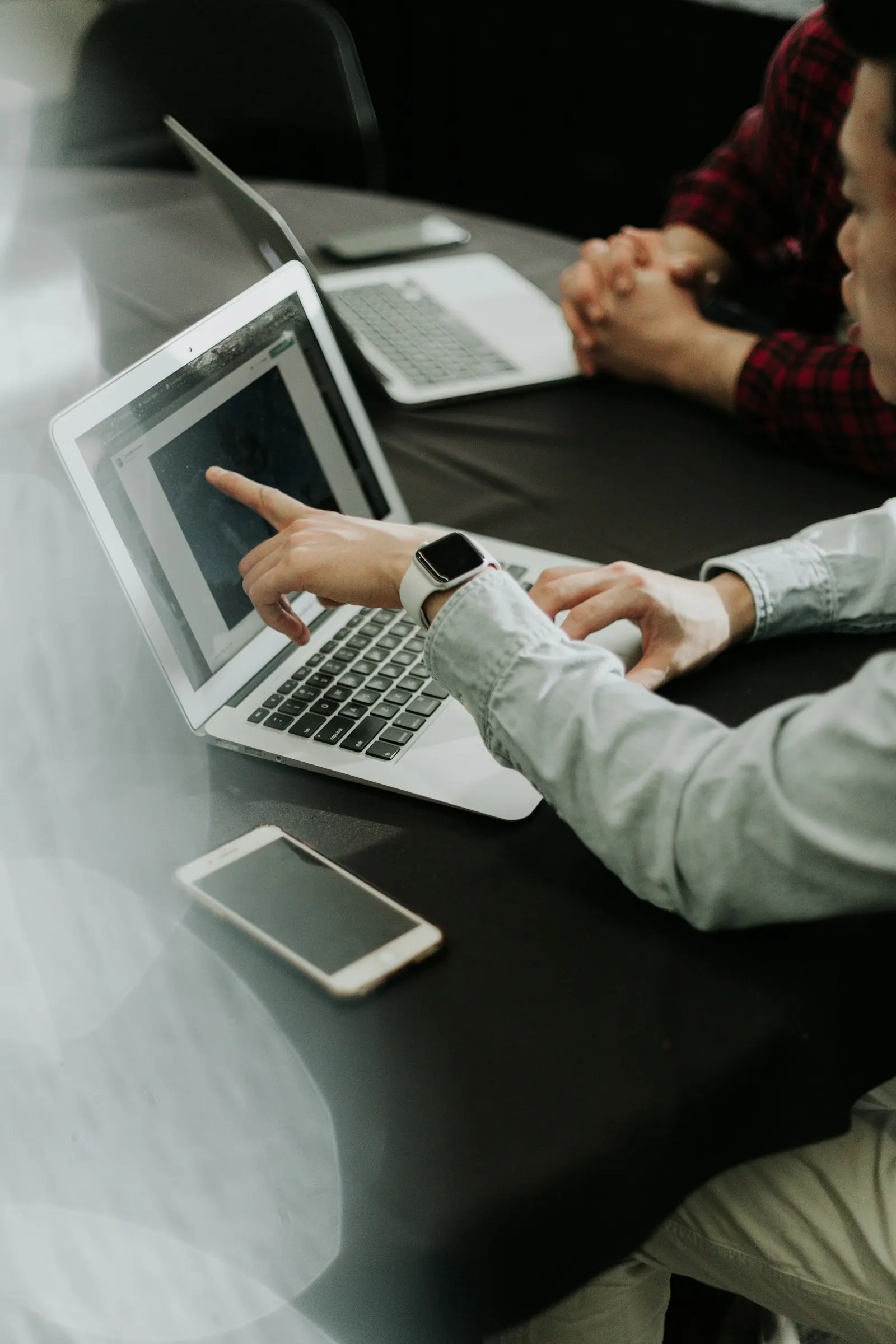 Small business team reviewing a technology plan together at a laptop