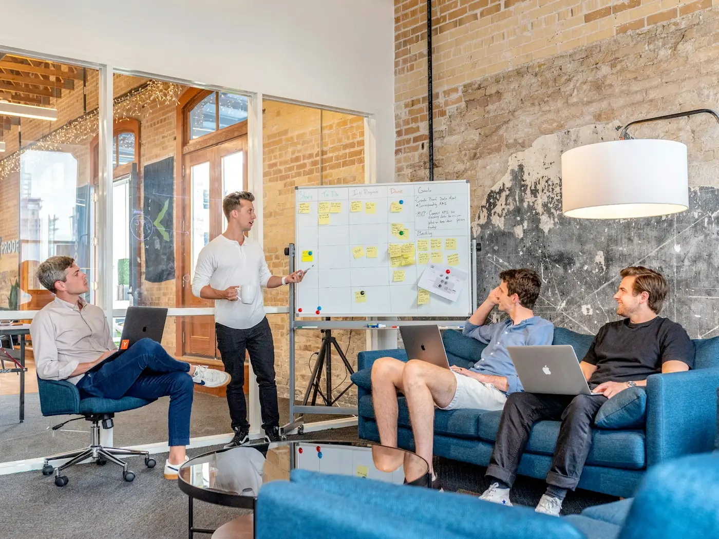 Technology advisor presenting a roadmap on a whiteboard to a seated business team